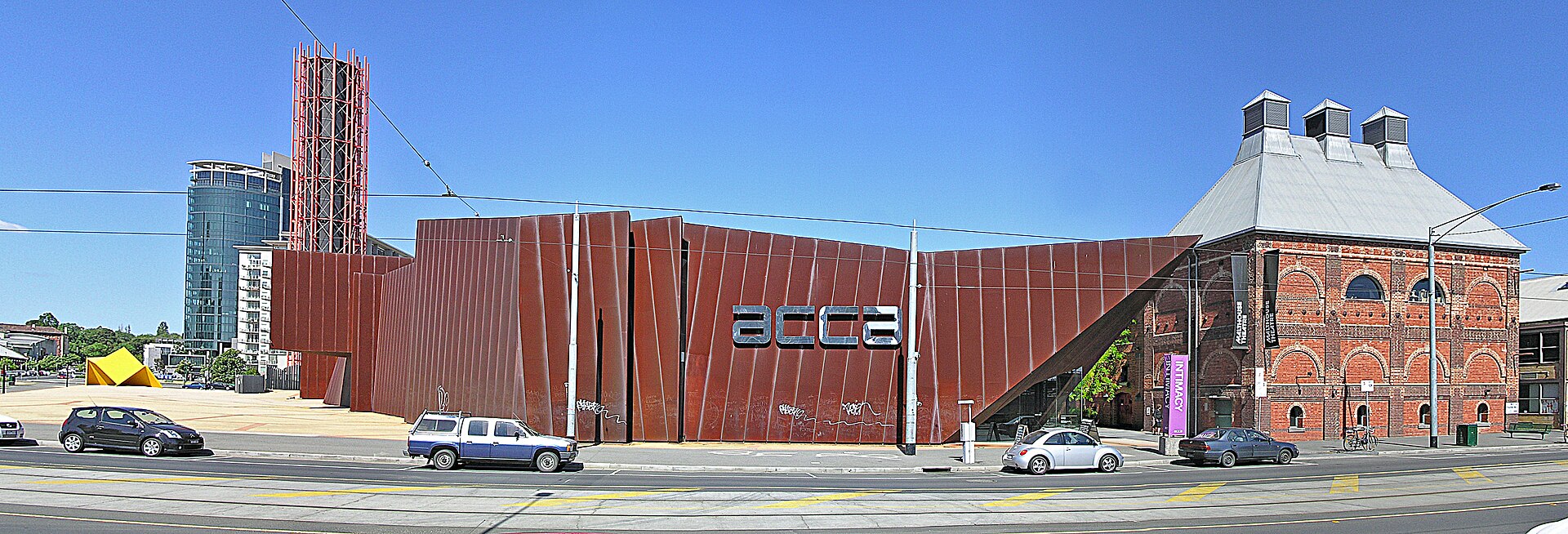 ACCA’s rust-coloured angular exterior beside the brick building on Sturt Street.