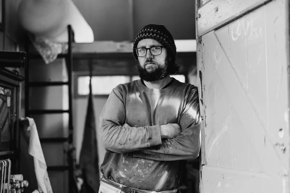 Black-and-white portrait of Andy Pye in the studio.