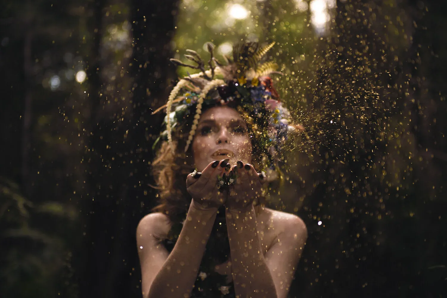 A costumed figure amid foliage and bright floating particles.