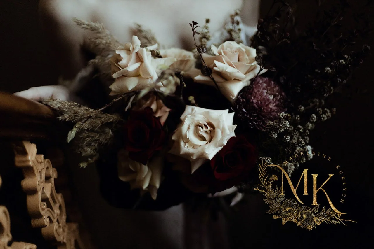 A dark bouquet beside the fine Madeleine Kuklych monogram.